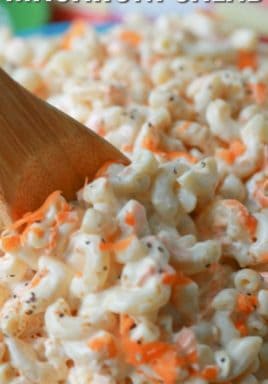 Classic macaroni salad with a wooden spoon and a title