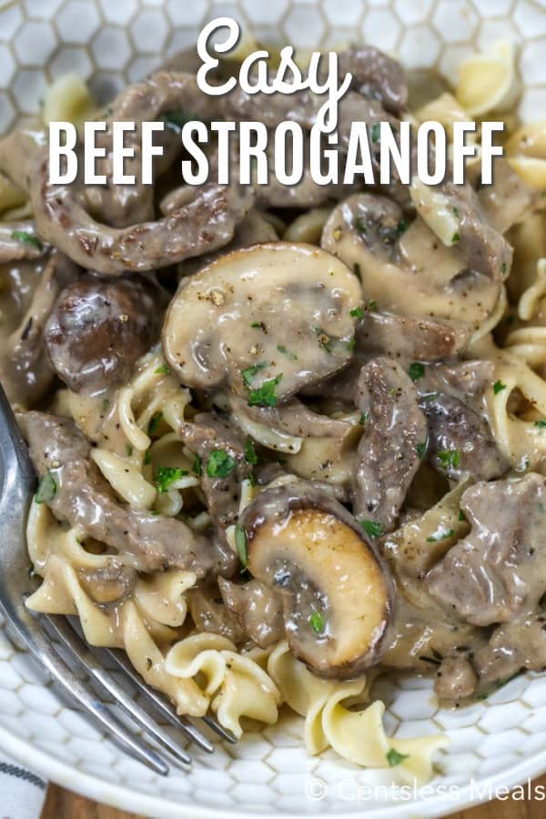 Beef stroganoff on a plate with a fork and a title