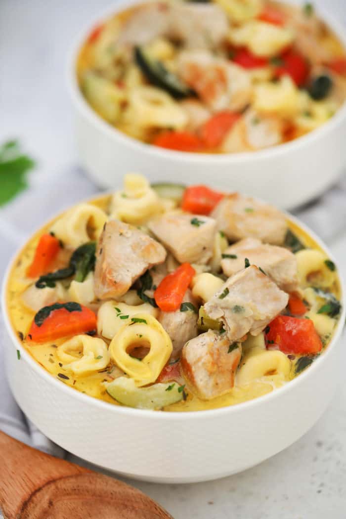 two white bowls of Chicken Tortellini Soup
