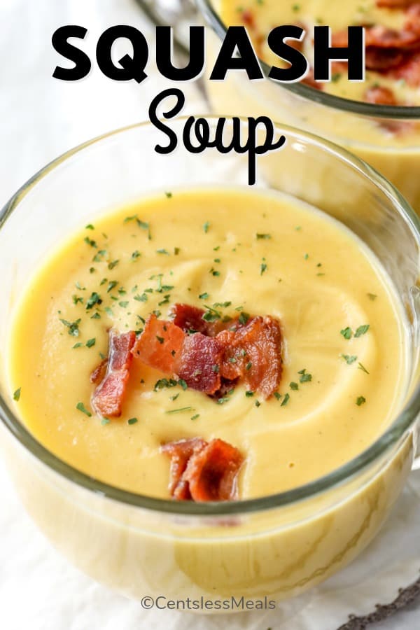 closeup of Squash Soup in a glass bowl with bacon garnish