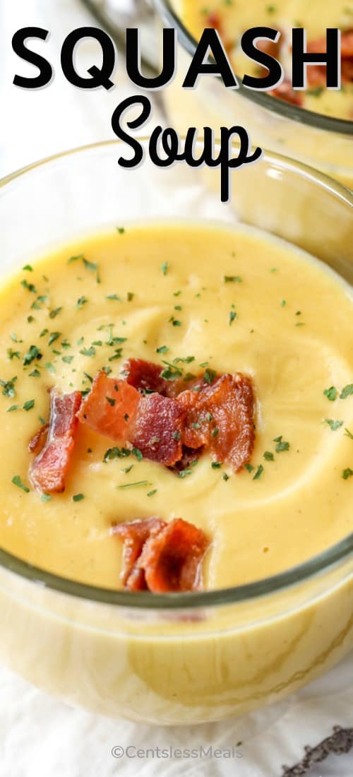 Squash Soup in a glass bowl with bacon garnish