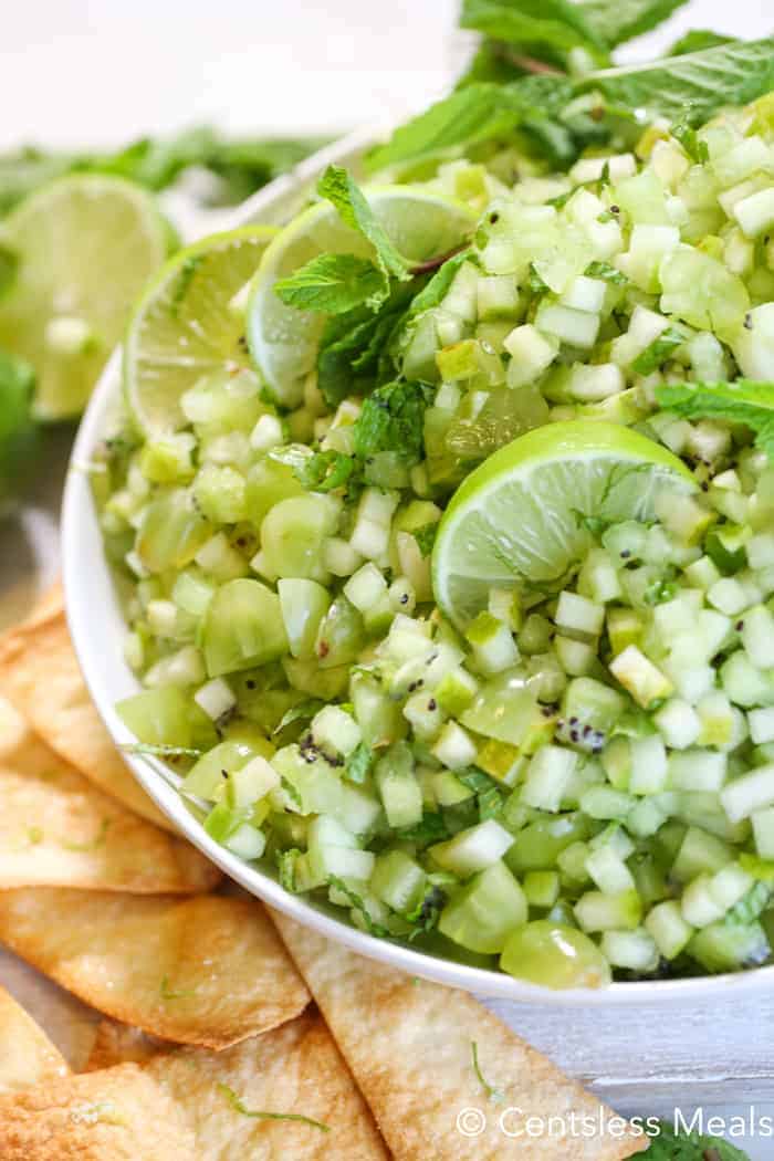 Mojito fruit salsa in a white bowl with chips on the side