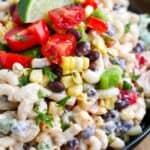 Southwestern macaroni salad in a bowl with a lime wedge on top