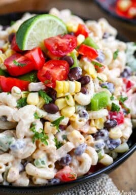 Southwestern macaroni salad in a bowl with a lime wedge on top