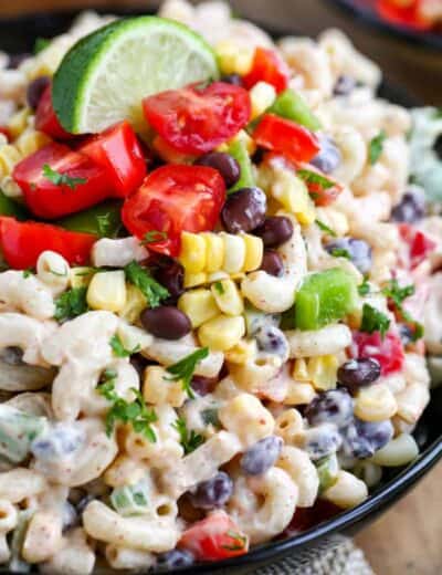 Southwestern macaroni salad in a bowl with a lime wedge on top