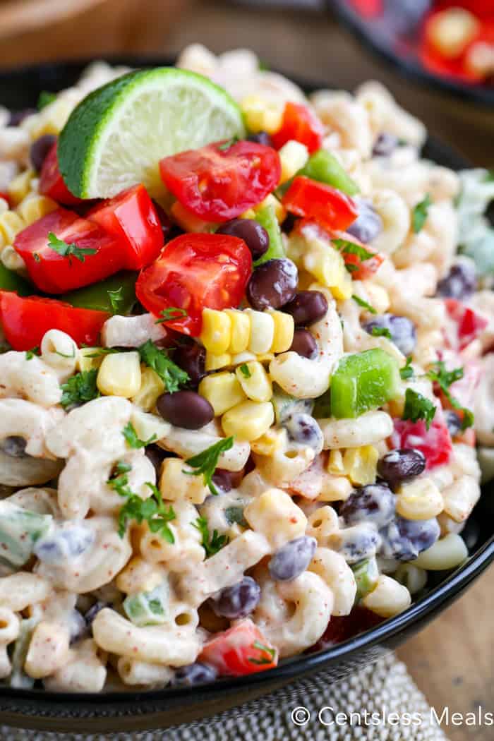 Southwestern macaroni salad in a bowl with a lime wedge on top