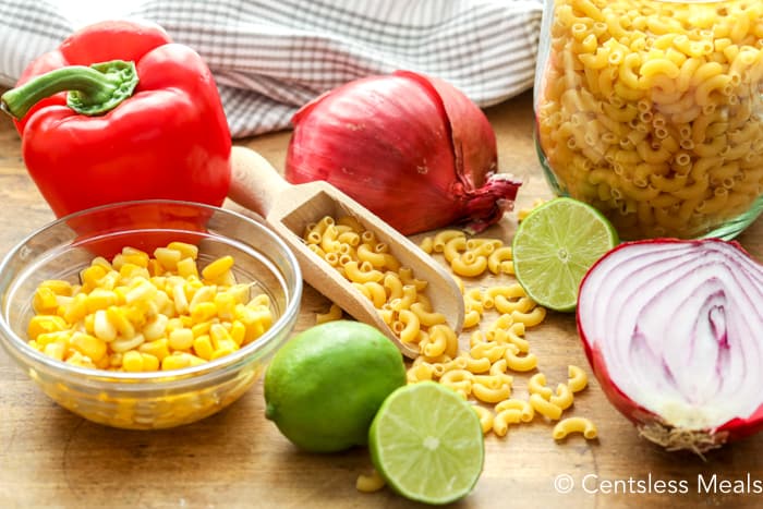 Ingredients for southwestern macaroni salad on a wooden board