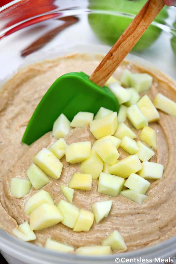 Cinnamon Apple Bread batter being mixed in a bowl with a rubber spatula