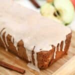 Cinnamon Apple Bread with icing on a wooden board
