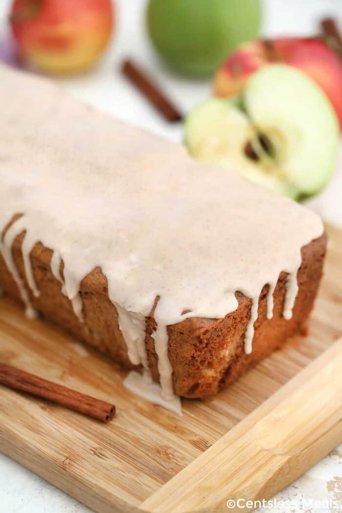 Cinnamon Apple Bread with icing on a wooden board