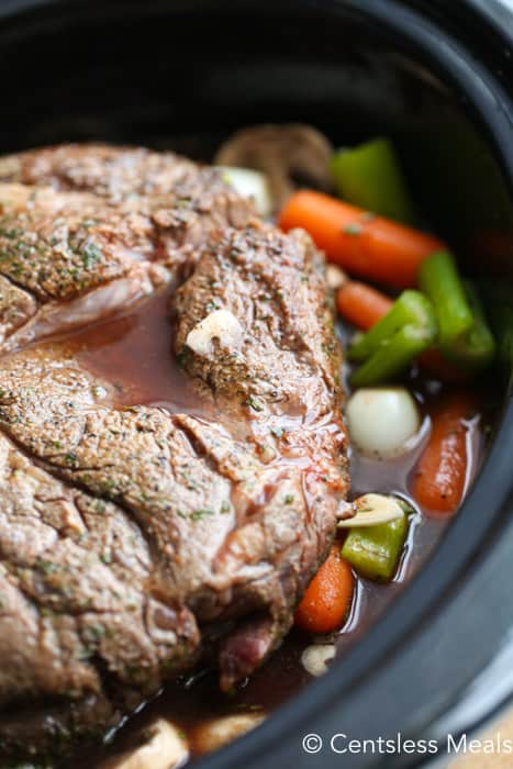 Slow cooker pot roast in a slow cooker with veggies