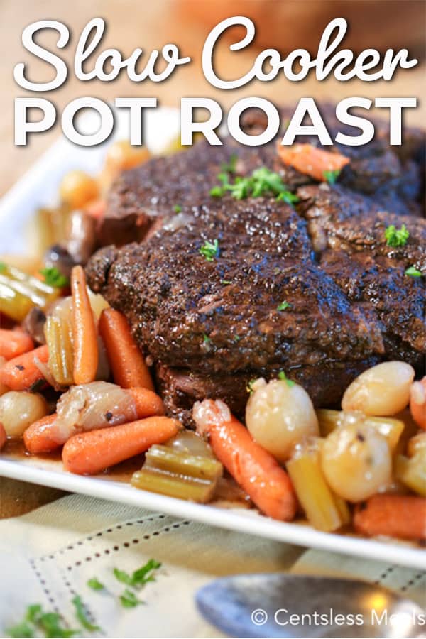 Slow cooker pot roast on a plate with veggies and a title
