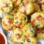 Pizza mac and cheese bites on a plate garnished with parsley