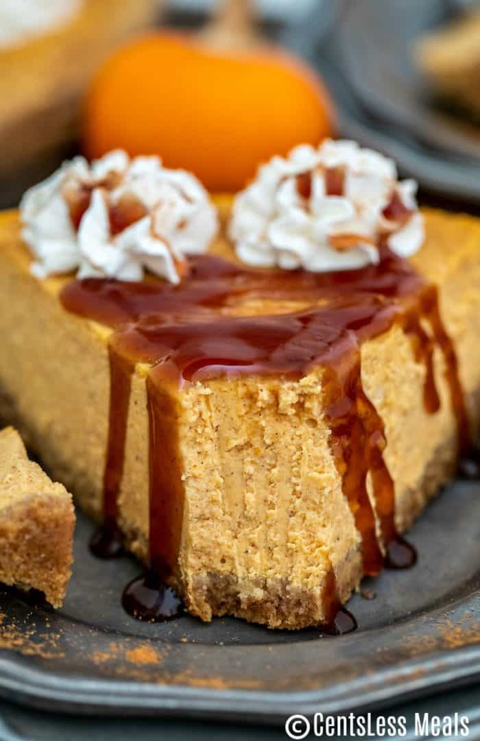 Pumpkin cheesecake on a plate with a bite taken out