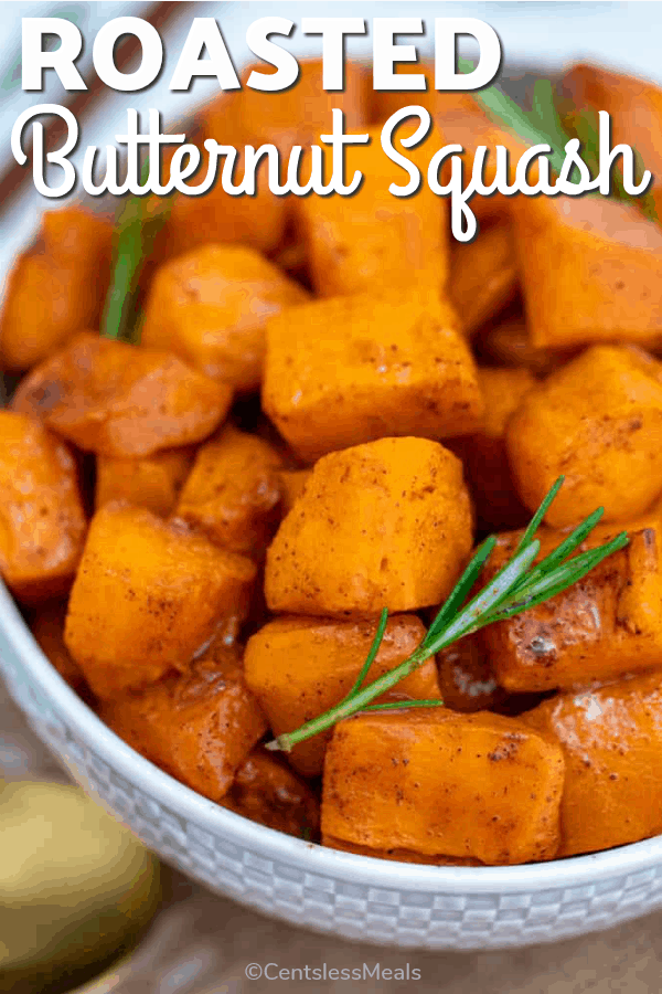 Roasted butternut squash in a bowl with rosemary and writing