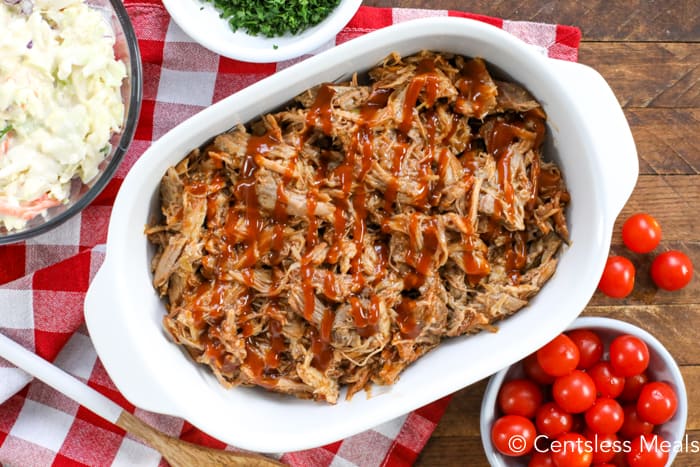 Pulled pork with sauce in a white casserole dish