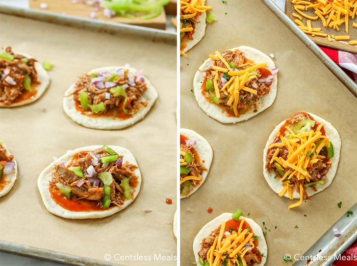 Raw pulled pork mini pizzas on a baking sheet