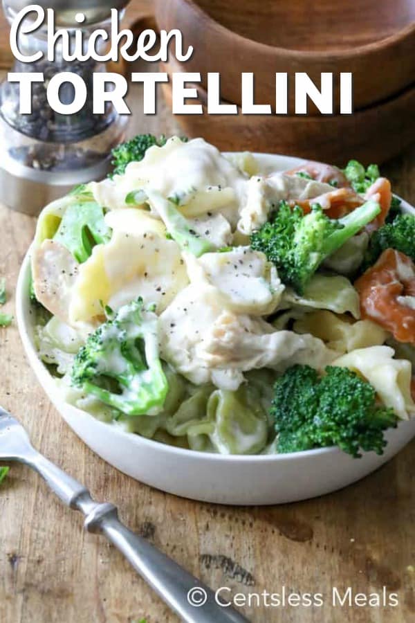 Chicken tortellini in a white bowl with broccoli and a title