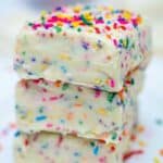 Squares of Vanilla Fudge stacked on top of each other on a plate