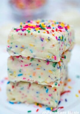 Squares of Vanilla Fudge stacked on top of each other on a plate