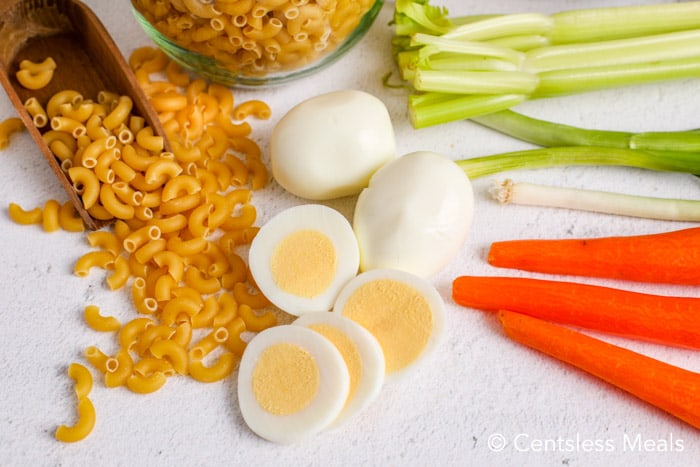 Macaroni salad with egg ingredients on a marble board