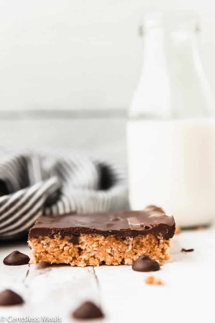 Peanut butter Rice Krispie Treat on a marble board with milk in the background