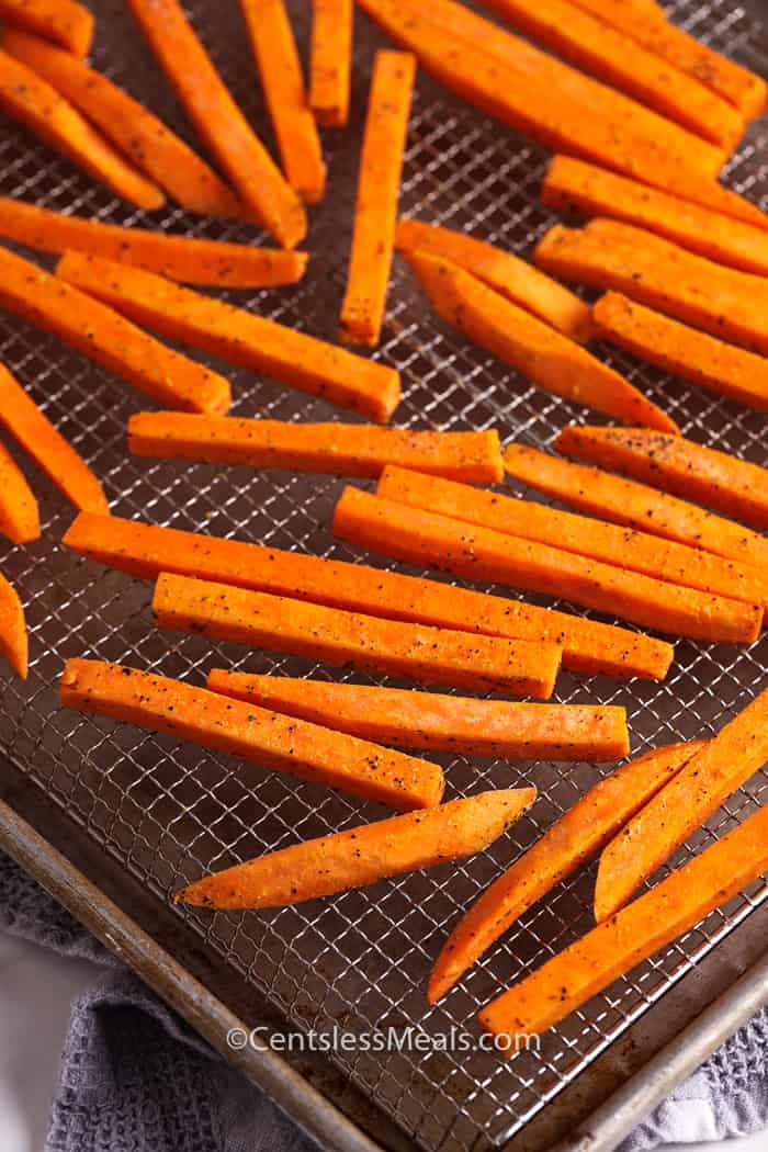 Raw sweet potato fries on a baking sheet