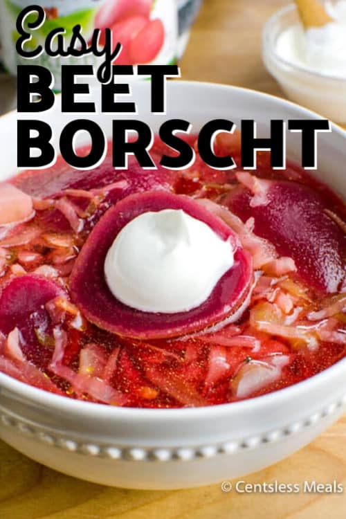Beet Borscht with a spoonful of sour cream resting on top a sliced beet with a title.