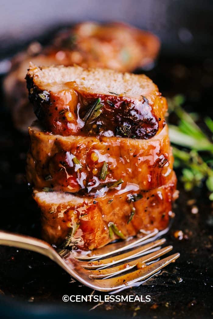 Honey Garlic Roasted Pork Tenderloin sliced and stacked in the skillet