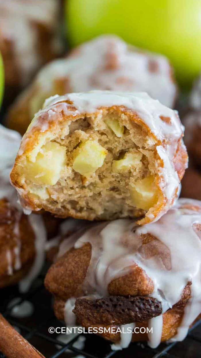 Glazed apple fritters with a bite out of one of them