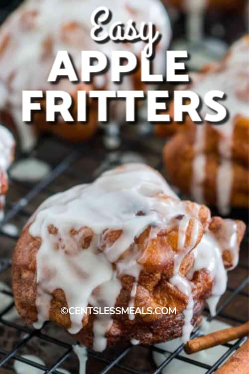 Glazed Apple Fritters on a wire cooling rack with writing.