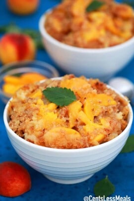 Peach Dump Cake in served in white bowls.