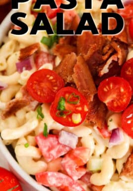 Bacon Ranch Pasta Salad in a white bowl, garnished with tomatoes, bacon and green onion, with a title.