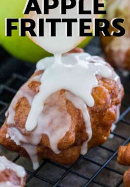 A white glaze being applied with a wooden spoon to Apple Fritters on a cooling rack with a title