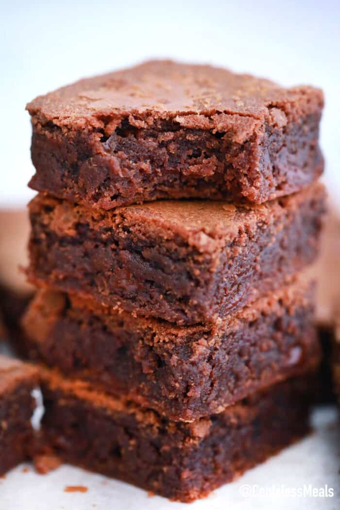 Nutella Brownies stacked with the top one having a bite taken out of it.