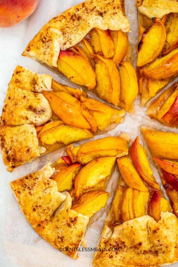 Peach galette sliced on a serving tray and ready to serve.