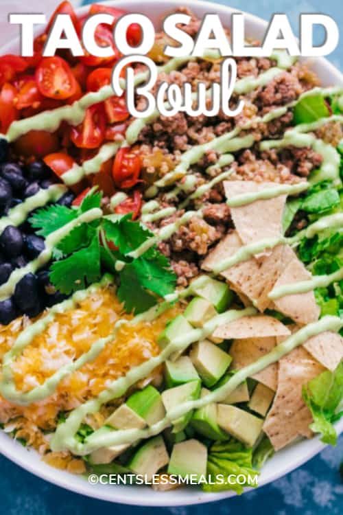 Taco Salad Bowl with creamy avocado dressing drizzled over the top, with a title.