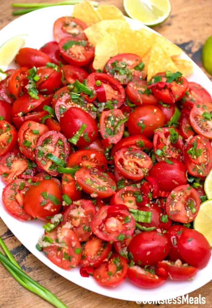Cherry tomato salad on a white serving plate.