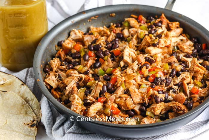 Enchilada Casserole ingredients cooking in a pan