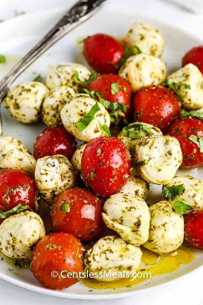 Pesto Caprese Salad on a white plate