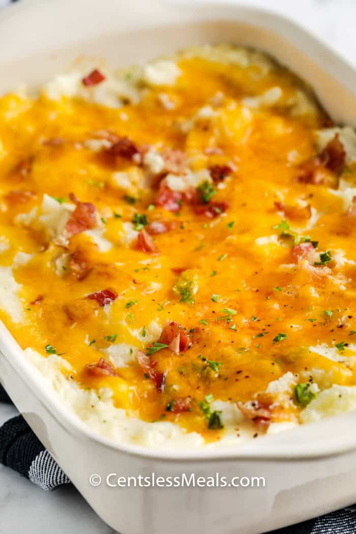 Loaded Mashed Potato Casserole with melted cheese on top after cooking