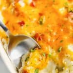 top view of Loaded Mashed Potato Casserole with a spoon inside