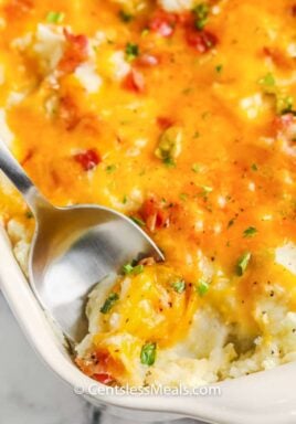 top view of Loaded Mashed Potato Casserole with a spoon inside