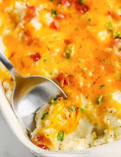 top view of Loaded Mashed Potato Casserole with a spoon inside