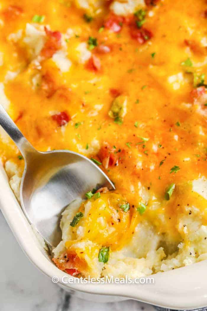 top view of Loaded Mashed Potato Casserole with a spoon inside