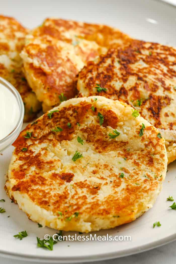 Loaded Mashed Potato Pancakes on a plate with garnish