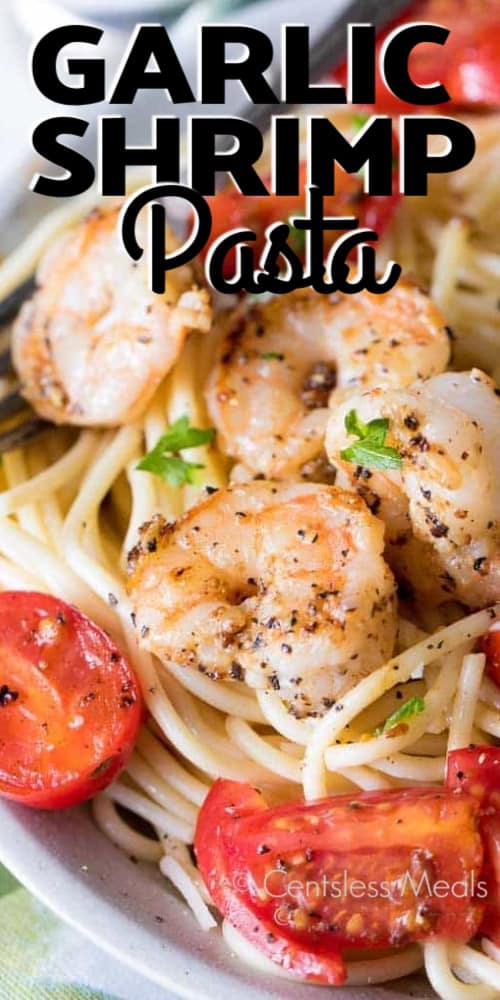 Garlic Shrimp Pasta in a white bowl with a fork with a title