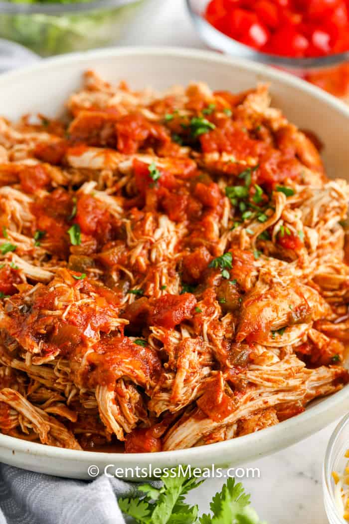 shredded chicken in a white bowl to make Crock Pot Chicken Tacos