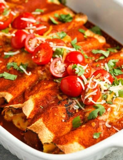 close up of cooked Chicken Enchiladas in a casserole dish