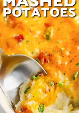 Loaded Mashed Potato Casserole with a serving being scooped up with a silver spoon, with a title.